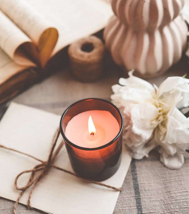 Amber jar candle within a whimsical setting
