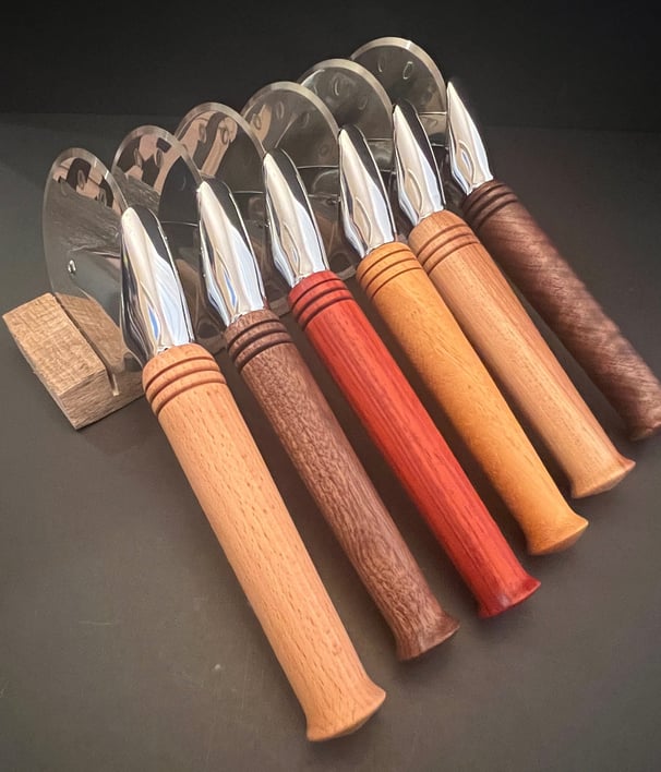 Collection of pizza cutters with various wood handles