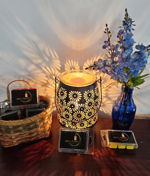 a table with a candle and a vase with flowers