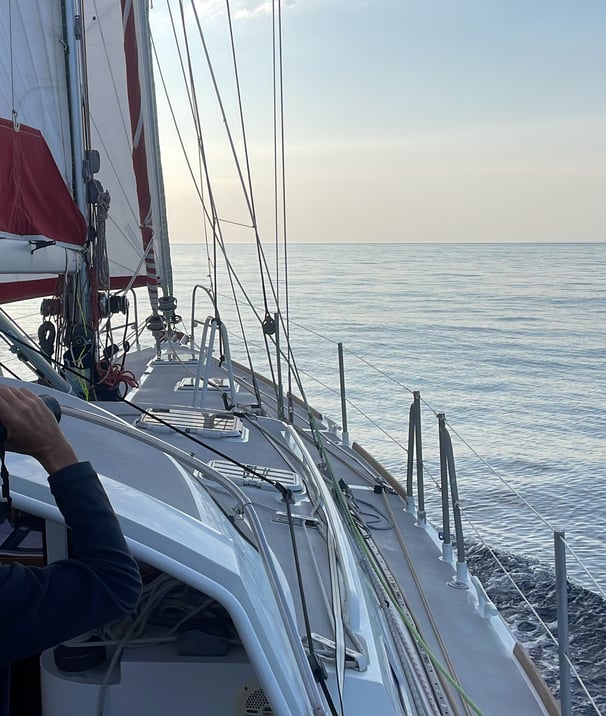 a man is taking a picture of a sailboat