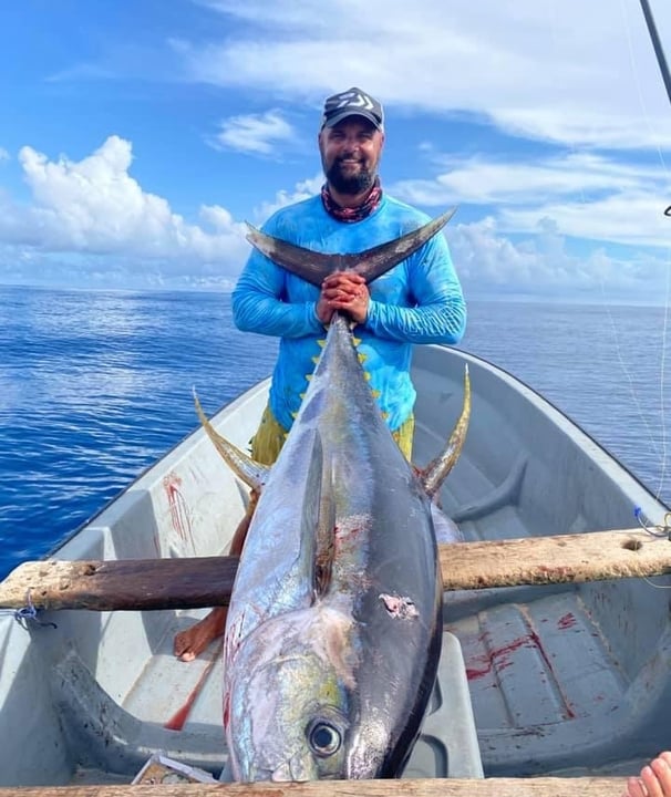 Zanzibar Fishing Trips – angler holding a massive Yellowfin Tuna on a fishing boat