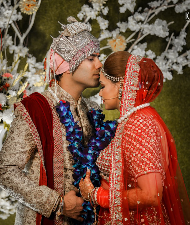 a man and woman kissing in a wedding ceremony