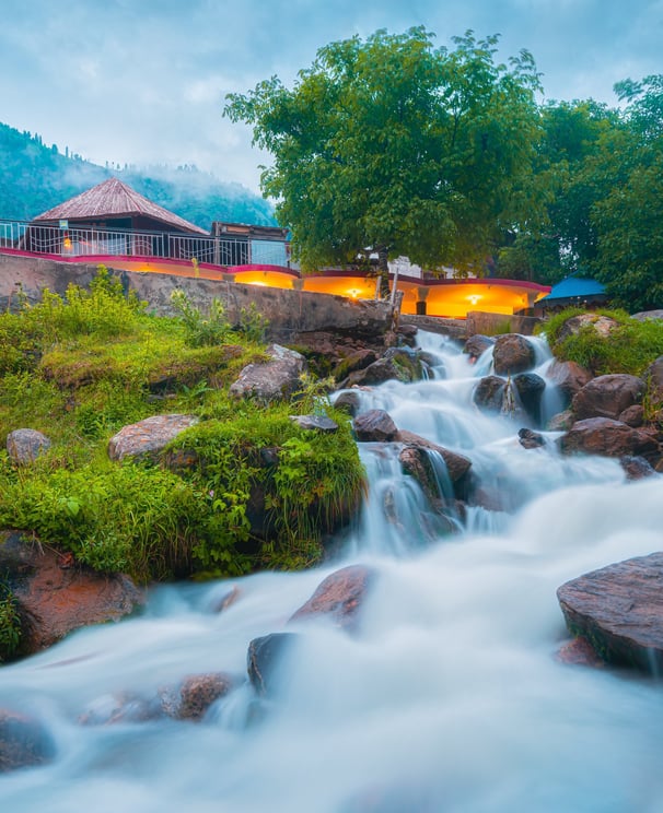 a waterfall flowing down a mountain side. arbab naimat kasi , kalam naran