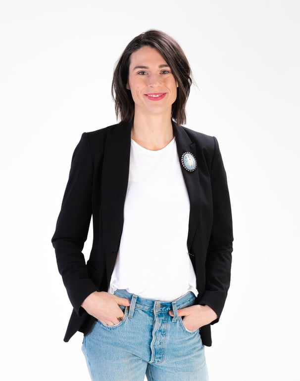 Rachel Hahn, a copywriter and owner of RC Copy & Creative Strategy, wearing jeans and a black blazer