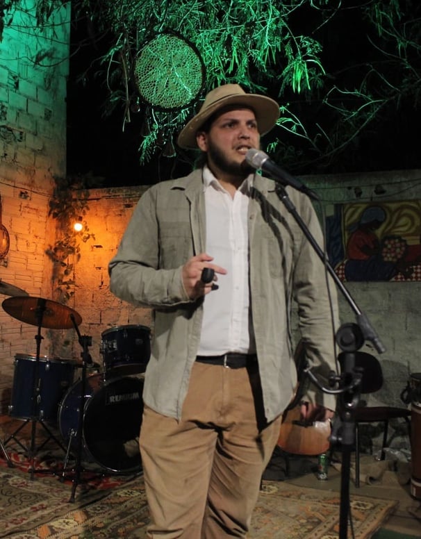 Matheus Henrique realizando um monólogo teatral como Coronel Fawcett no evento do Instituto