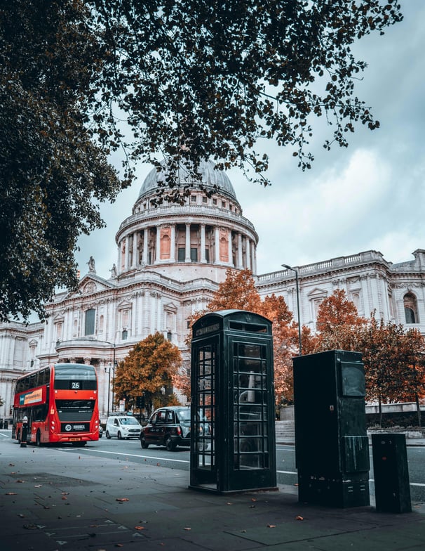 a red bus and a red bus in front of St. Paul's Cathedral London