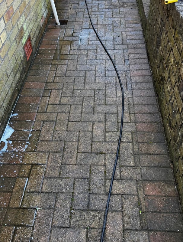 a hose is attached to a brick wall