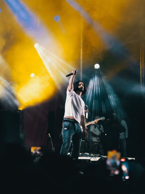 a man standing on a stage with a microphone and a microphone, festival de jazz, montreal