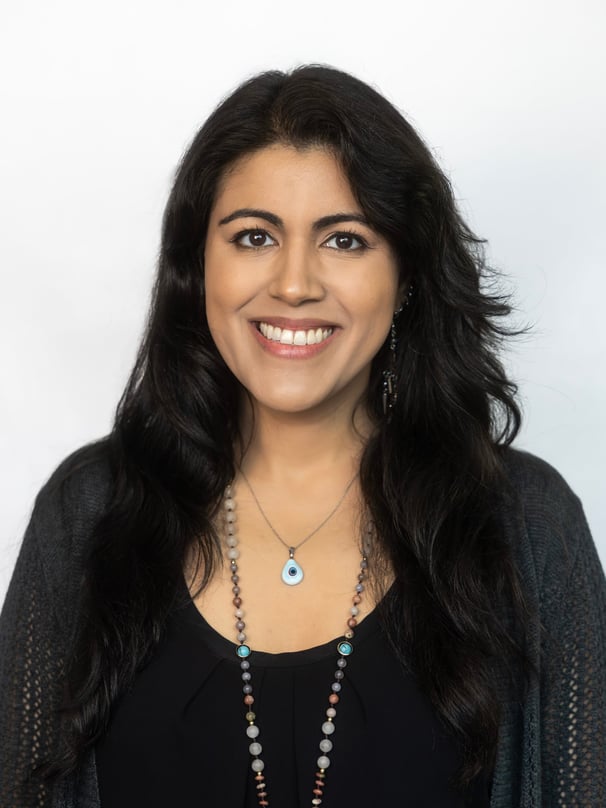 a woman with long hair and a necklace with a evil eyeball