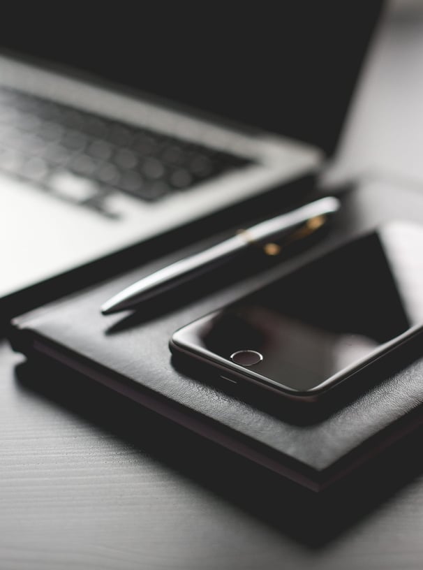 a laptop and a cell phone on a desk