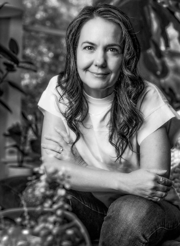 a woman sitting on a chair in a garden