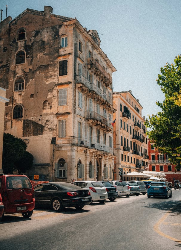 a street scene with a bus and cars parked on the side of the road