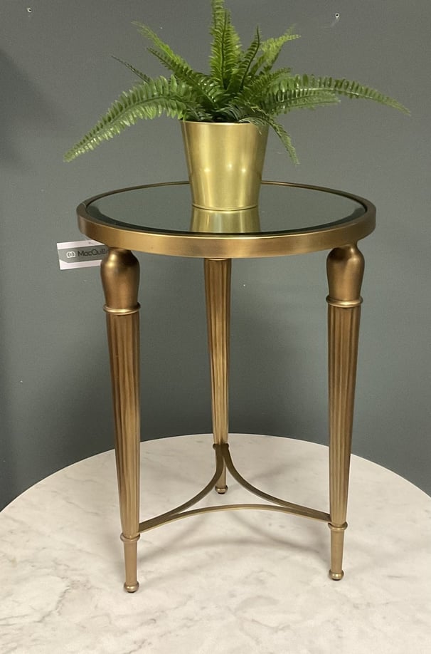brass end table with greenery