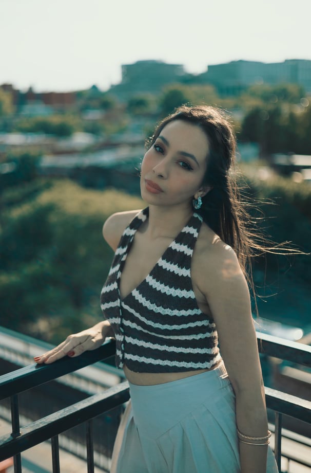 a woman in a striped top and skirt