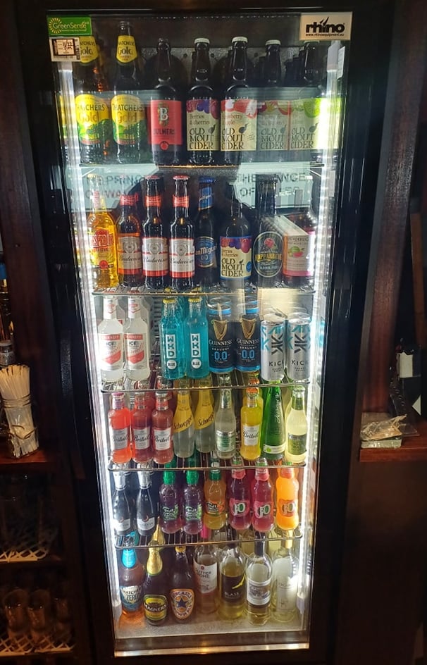 a refrigerator with a glass door that is filled with alcohol