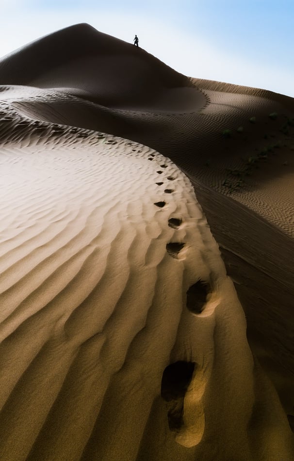 a person walking on a sand dune dune dune dune dune dune dune dune dune dune