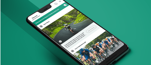 a smartphone phone showing a mobile phone screen displaying a photo of a person riding a bike