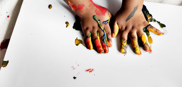 a child's hands painted with paint and paint