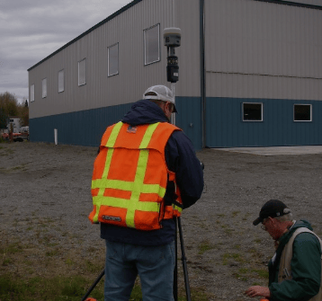 a man in a safety vest and a camera