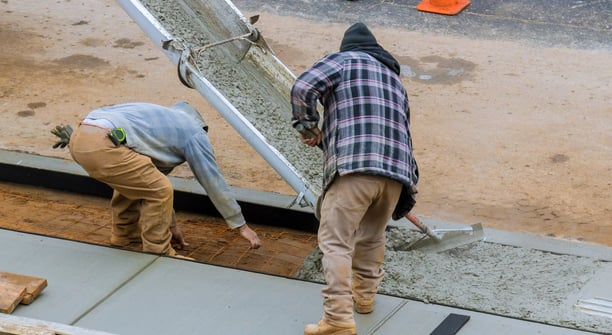 two men working on a concrete slab