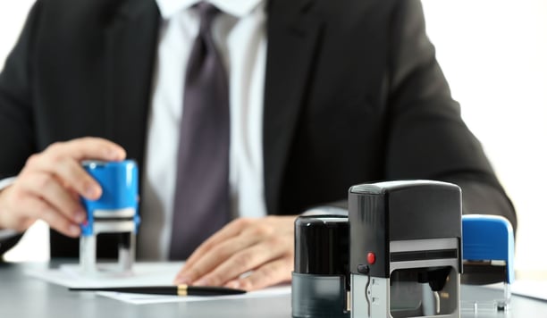a man in a suit and tie tie and a stamper