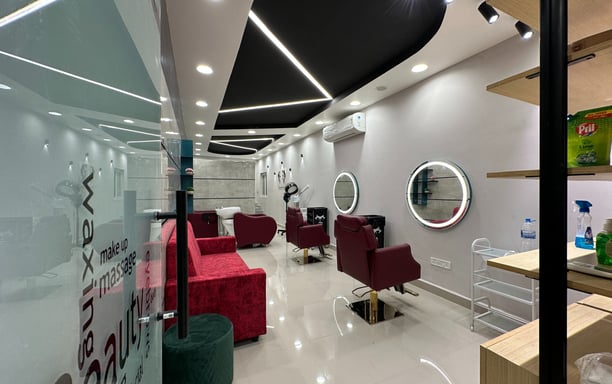 a salon with a red couch and a mirror