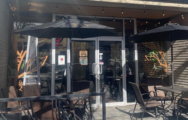 a coffee house with tables and chairs with an outside patio