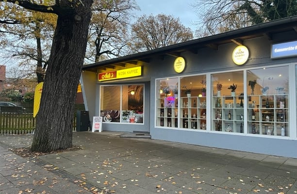 a store front of a store with a clock on the front of it