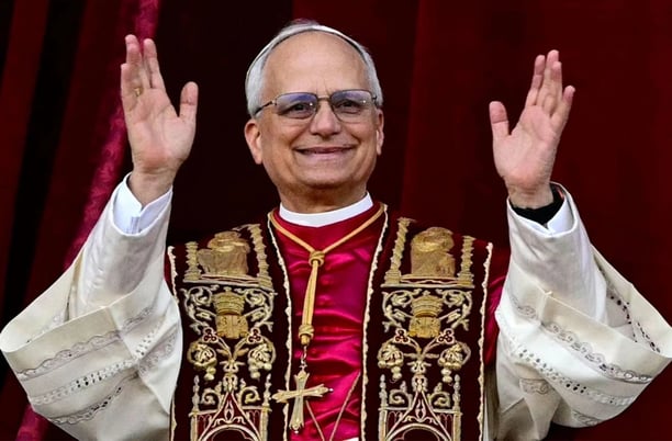 Papa Leon XIV in a priest's robes and glasses