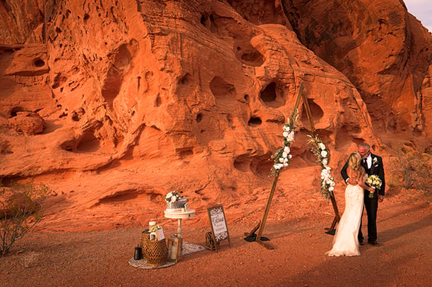 a man and woman standing in front of a mountain