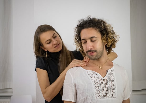 woman massaging mans shoulders
