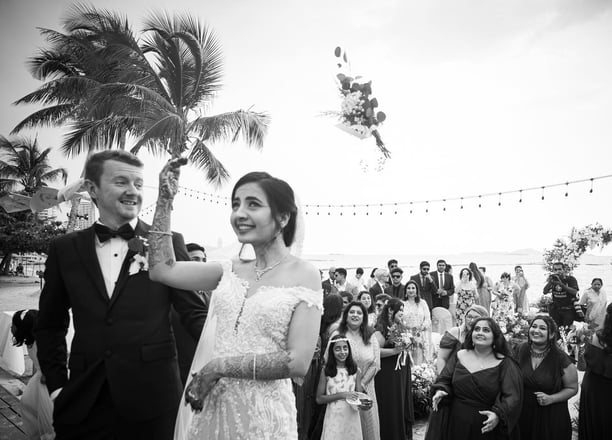 a bride and groom are standing in front of a crowd of people