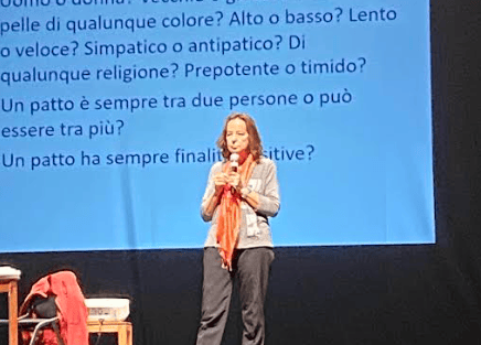 a woman standing on a stage with a microphone and a microphone