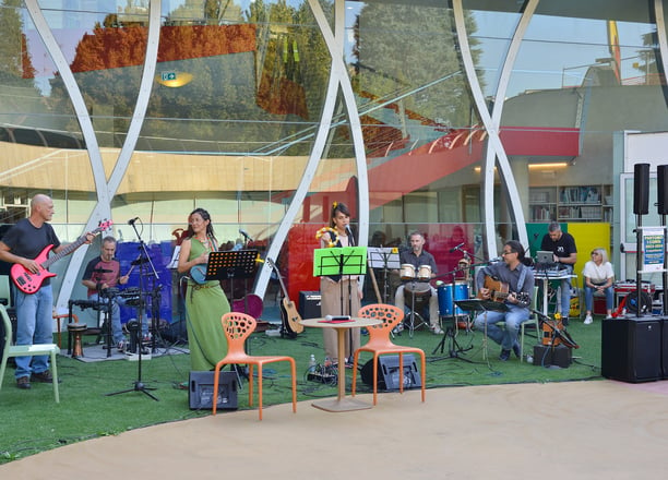 a band playing music in a large outdoor area