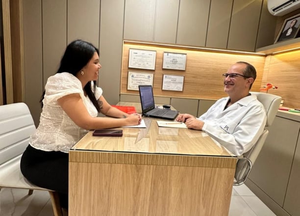 médico ginecologista em consulta com paciente mulher, ambos sorrindo