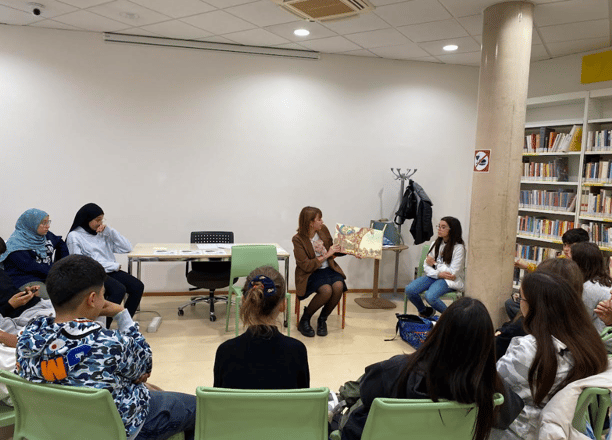 a group of people sitting in chairs in a room