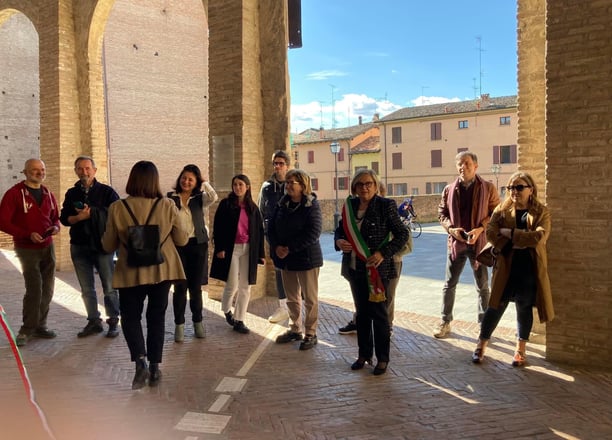 a group of people standing in a line of arches