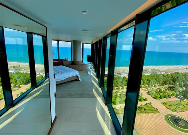 a bedroom with a bed and a view of the sea