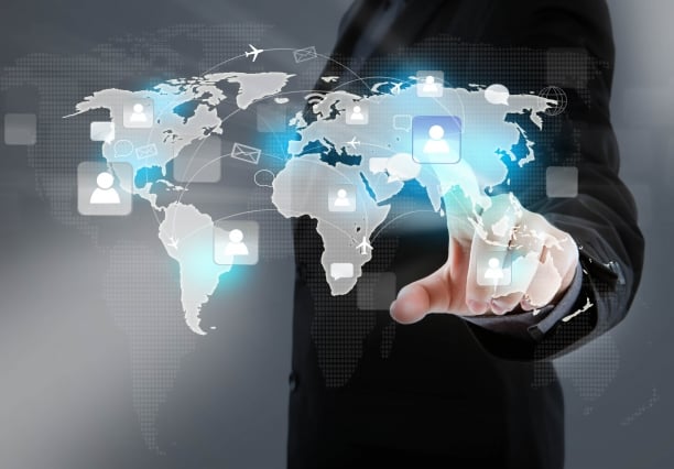 a man in a suit is holding a tablet with a map of the world