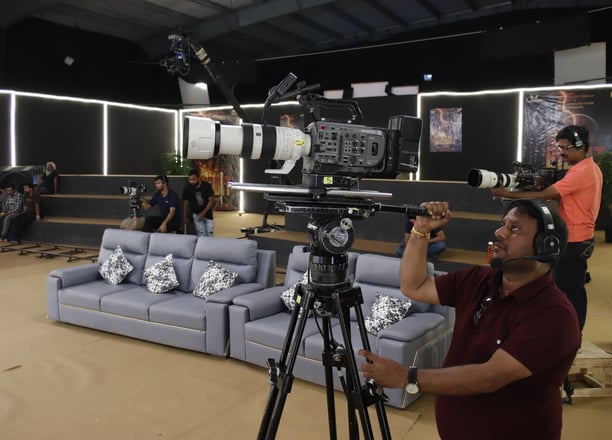 a man is filming a video camera and a camera