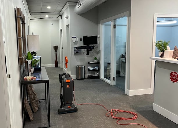 a vacuum cleaner cleaning the carpet in a dental office.