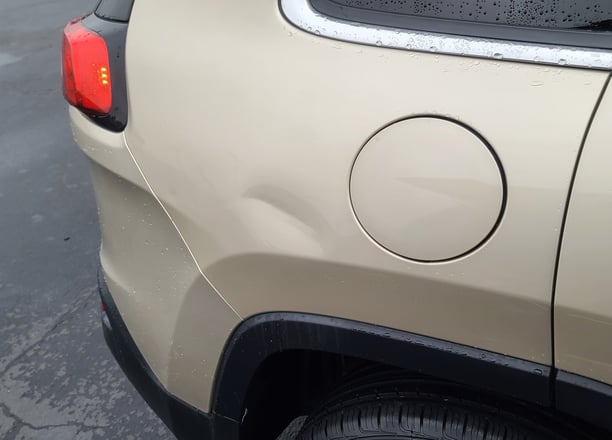 Large dent in Jeep Cherokee before pdr repair