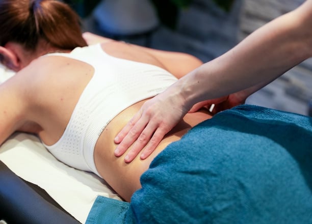 Sports Therapist providing a back massage to a client