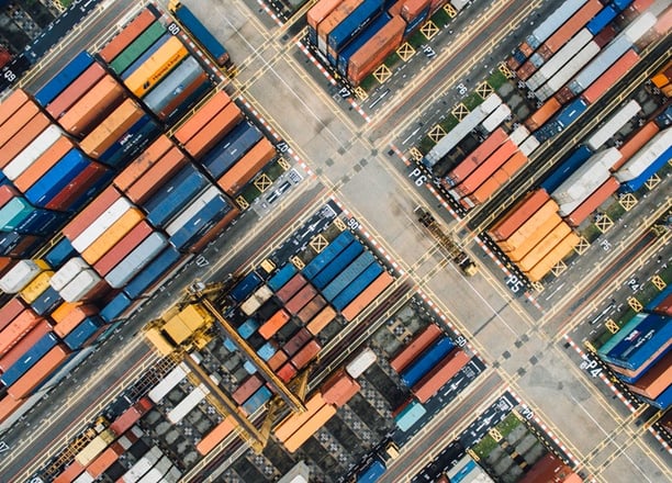 an aerial view of a large number of containers stacked in a port terminal