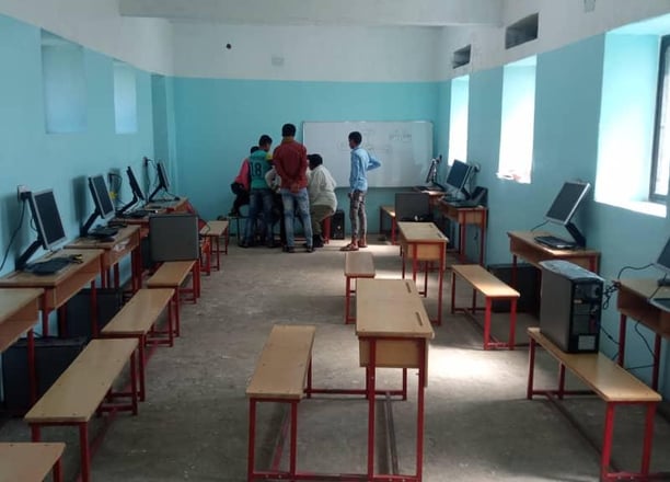 a classroom with desks and computers and desks