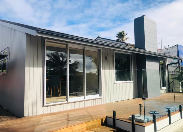 a house with a deck and a deck with a view of the ocean