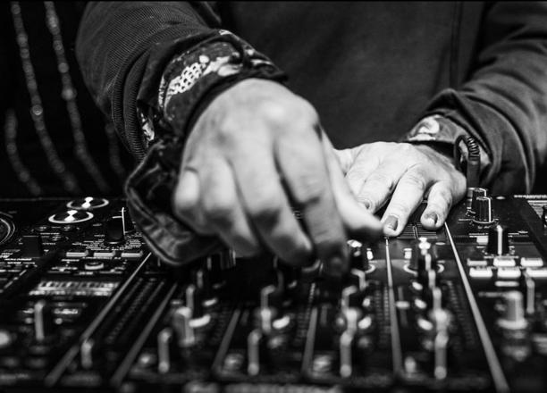 a dj mixing music in a dj booth