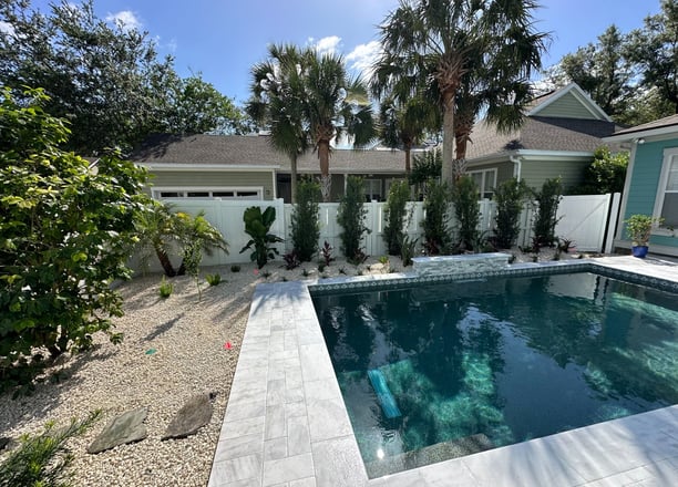 a pool with a pool and a house in the background
