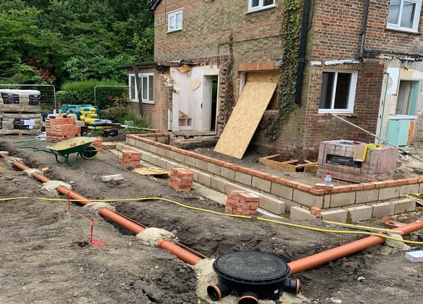 Groundwork contractor installing drainage system