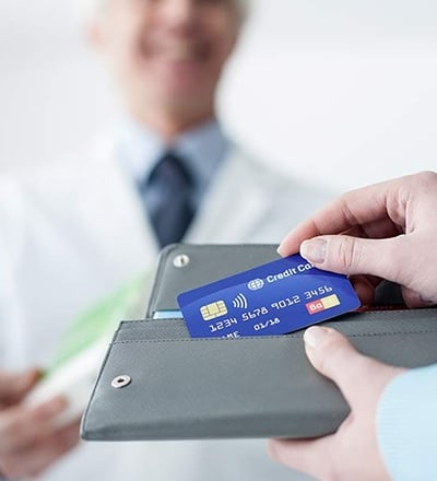 a doctor holding a credit card